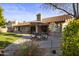 Inviting backyard patio with dining set and well-maintained landscaping at 76 W Stacey Ln, Tempe, AZ 85284