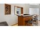 Inviting bar area features custom wooden cabinets, a wine rack, and a granite countertop with seating for a relaxed entertaining space at 76 W Stacey Ln, Tempe, AZ 85284