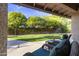 Relaxing covered patio featuring comfortable seating and a view of the lush backyard at 76 W Stacey Ln, Tempe, AZ 85284