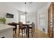 Well-lit dining area features a wooden table and chairs with large windows at 76 W Stacey Ln, Tempe, AZ 85284