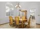 Cozy dining room featuring a wooden table with seating for six and a modern chandelier at 76 W Stacey Ln, Tempe, AZ 85284
