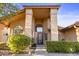 Inviting home entrance with arched windows, manicured bushes and walkway lighting at 76 W Stacey Ln, Tempe, AZ 85284