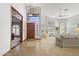 Bright foyer features tile flooring, high ceilings, a wooden front door, and large arched window at 76 W Stacey Ln, Tempe, AZ 85284