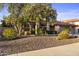 Charming home nestled behind mature flowering trees and lush desert landscaping at 76 W Stacey Ln, Tempe, AZ 85284