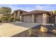 Spacious three car garage with neutral doors and desert landscaping at 76 W Stacey Ln, Tempe, AZ 85284