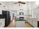 Bright kitchen with white cabinetry, quartz countertops, black appliances, and a center island at 76 W Stacey Ln, Tempe, AZ 85284