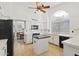White kitchen featuring an island with a dark countertop and stainless steel appliances at 76 W Stacey Ln, Tempe, AZ 85284