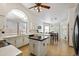 Kitchen with island and breakfast nook featuring white cabinets and stainless steel appliances at 76 W Stacey Ln, Tempe, AZ 85284