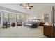 Spacious main bedroom suite with plush carpet, ceiling fan, bay window, and a seating area for a serene retreat at 76 W Stacey Ln, Tempe, AZ 85284