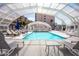 Enclosed community pool surrounded by lounge chairs and sun umbrellas at 7920 E Camelback Rd # 203, Scottsdale, AZ 85251