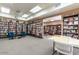 Large community library with walls of bookshelves, tables, chairs, and ample lighting at 7920 E Camelback Rd # 203, Scottsdale, AZ 85251