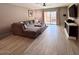 Bright living room with a comfortable couch, wooden floors, and access to an outdoor balcony at 7920 E Camelback Rd # 203, Scottsdale, AZ 85251