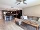 Open living space featuring wooden flooring, a ceiling fan, and an inviting gray couch at 7920 E Camelback Rd # 203, Scottsdale, AZ 85251