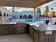 Outdoor kitchen area with stainless steel grill and countertop overlooking the swimming pool and lounge area at 7920 E Camelback Rd # 203, Scottsdale, AZ 85251
