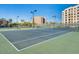 Well-maintained community tennis court with surrounding landscaping and blue sky at 7920 E Camelback Rd # 203, Scottsdale, AZ 85251