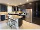 Modern kitchen featuring dark wood cabinets, stainless steel appliances, and a large center island at 820 N 8Th Ave # 22, Phoenix, AZ 85007