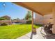 Covered patio area with landscaped backyard featuring a pool at 8637 W Kathleen Rd, Peoria, AZ 85382