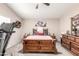 Cozy bedroom with a wood bed frame, a floral-themed bedspread, a ceiling fan, and soft lighting at 8637 W Kathleen Rd, Peoria, AZ 85382