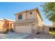Front exterior featuring a two-car garage and neutral tones with xeriscape landscaping at 8637 W Kathleen Rd, Peoria, AZ 85382