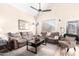 Spacious living area offers a vaulted ceiling, ceiling fan, and wood-look floors at 8637 W Kathleen Rd, Peoria, AZ 85382