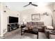 Comfortable living room showcasing a ceiling fan, and wood-look flooring at 8637 W Kathleen Rd, Peoria, AZ 85382