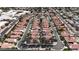 Expansive aerial view showcasing a community of red-roofed homes and manicured landscaping at 8804 E Sunnyside Dr, Scottsdale, AZ 85260