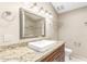 Elegant bathroom vanity featuring granite countertop, framed mirror, and modern fixtures at 8804 E Sunnyside Dr, Scottsdale, AZ 85260