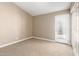 Spacious bedroom featuring neutral carpet and a glass door leading to outdoor area at 8804 E Sunnyside Dr, Scottsdale, AZ 85260