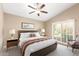 Bright bedroom with a ceiling fan, a large bed, and plenty of natural light at 8804 E Sunnyside Dr, Scottsdale, AZ 85260