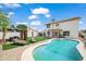 Serene backyard featuring a private pool, a covered patio, and lush greenery, perfect for relaxation at 9818 W Pontiac Dr, Peoria, AZ 85382