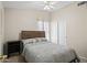 Well-lit bedroom showcasing a comfortable bed, a side table, and a sliding door closet at 9818 W Pontiac Dr, Peoria, AZ 85382