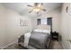 Comfortable bedroom featuring a ceiling fan, neutral decor, and natural light at 9818 W Pontiac Dr, Peoria, AZ 85382