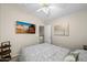 Cozy bedroom with a flat-screen TV, natural light, and easy access to the upper level at 9818 W Pontiac Dr, Peoria, AZ 85382