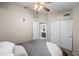 Neutral bedroom showcasing access to an ensuite bathroom and closet with sliding doors at 9818 W Pontiac Dr, Peoria, AZ 85382