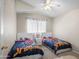 Cozy bedroom featuring two beds with Marvel Spider-Personal themed bedding and a ceiling fan at 9818 W Pontiac Dr, Peoria, AZ 85382