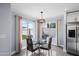 Eat-in kitchen with bright light, a view of the yard, and stainless steel refrigerator at 9818 W Pontiac Dr, Peoria, AZ 85382