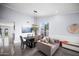 Open floor plan dining area with contemporary decor, adjacent seating, and bright natural light at 9818 W Pontiac Dr, Peoria, AZ 85382