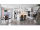 Kitchen features white cabinets, marble countertops, stainless steel appliances, and an island with seating at 9818 W Pontiac Dr, Peoria, AZ 85382