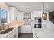 Kitchen boasts white cabinets, marble backsplash, stainless steel appliances, and an island at 9818 W Pontiac Dr, Peoria, AZ 85382