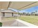 Relaxing covered back porch overlooking well-maintained lawn at 10815 W Hatcher Rd, Sun City, AZ 85351