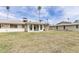 Lawn and the building's rear elevation. Palm trees punctuate the sky at 10815 W Hatcher Rd, Sun City, AZ 85351