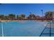 Outdoor blue basketball court surrounded by a chain link fence, providing an athletic amenity at 10815 W Hatcher Rd, Sun City, AZ 85351