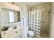 Updated bathroom featuring a glass block shower, vanity, and modern fixtures at 10815 W Hatcher Rd, Sun City, AZ 85351