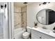 Updated bathroom with shower-tub combination and a modern vanity at 10815 W Hatcher Rd, Sun City, AZ 85351