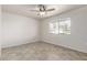 Neutral bedroom features a ceiling fan and a bright window at 10815 W Hatcher Rd, Sun City, AZ 85351