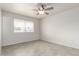 Bright bedroom with tile flooring, ceiling fan, and a large window at 10815 W Hatcher Rd, Sun City, AZ 85351