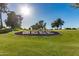 Scenic view of SCCC landmark on golf course with blue skies at 10815 W Hatcher Rd, Sun City, AZ 85351