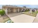 Inviting single-story home with a convenient covered parking area and manicured lawn at 10815 W Hatcher Rd, Sun City, AZ 85351