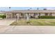 Charming single story home featuring a well-manicured lawn and a covered carport at 10815 W Hatcher Rd, Sun City, AZ 85351