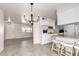 Open floorplan with kitchen featuring white cabinets, granite counters, and bar seating at 10815 W Hatcher Rd, Sun City, AZ 85351